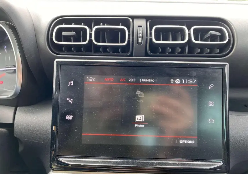 Vue rapprochée de l’écran tactile central et des aérateurs du tableau de bord du Citroën C3 Aircross blanc 2023.