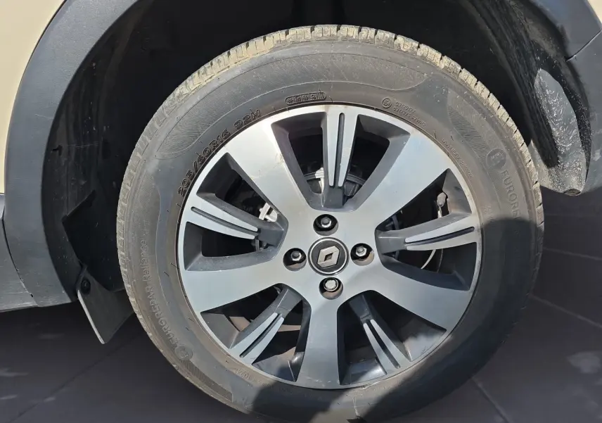 Vue rapprochée de l’écran tactile et des commandes de climatisation du tableau de bord noir du Renault Captur ivoire 2018.