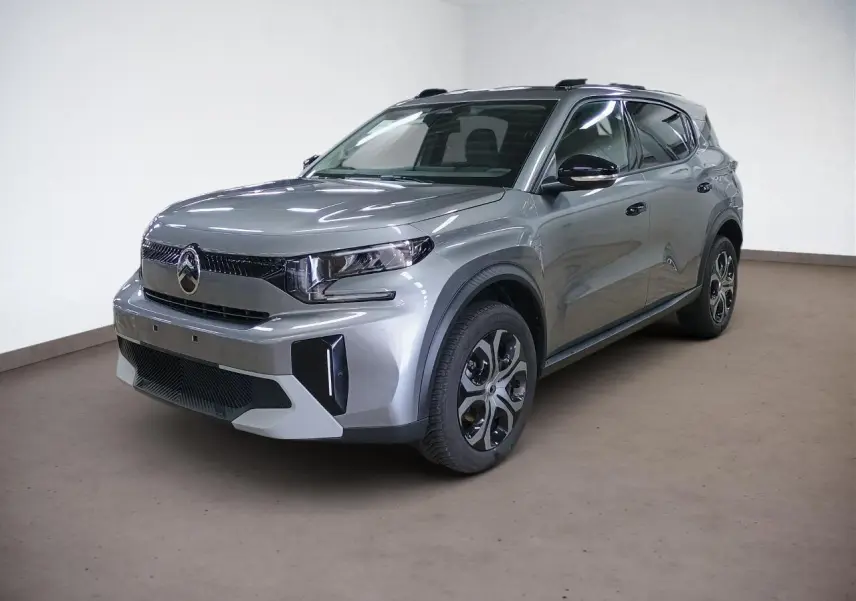 Citroën C3 Aircross Hybrid gris Mercury en 3/4 avant droit, avec jantes spécifiques et barres de toit noires.