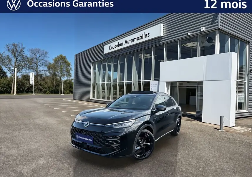 Volkswagen T-Roc noir en 3/4 avant droit, avec jantes noires et toit ouvrant panoramique visible, devant un showroom.
