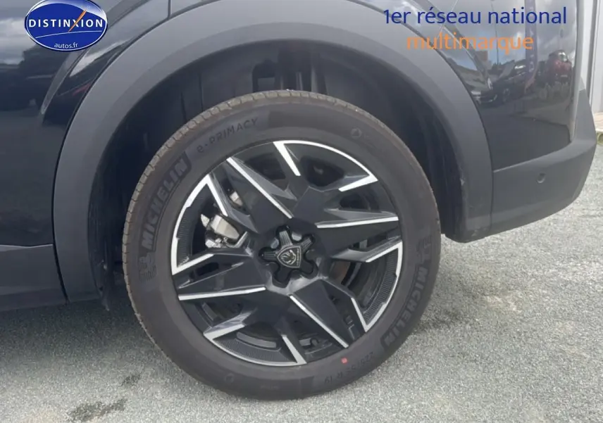 Gros plan sur la roue arrière droite noire avec jante alu au design moderne du Peugeot 5008 Hybrid 145 allure e-dcs6 2025.