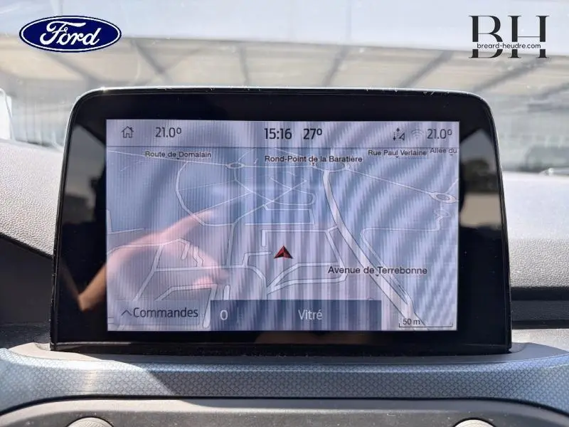 Écran tactile central affichant la navigation GPS dans l'habitacle de la Ford Focus noir Agate, vue de face rapprochée.