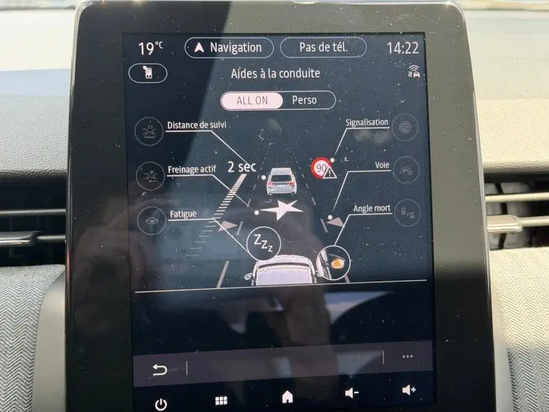 Écran tactile intérieur de la Renault Clio 1.6 E-Tech 2025 affichant les aides à la conduite en mode hybride.