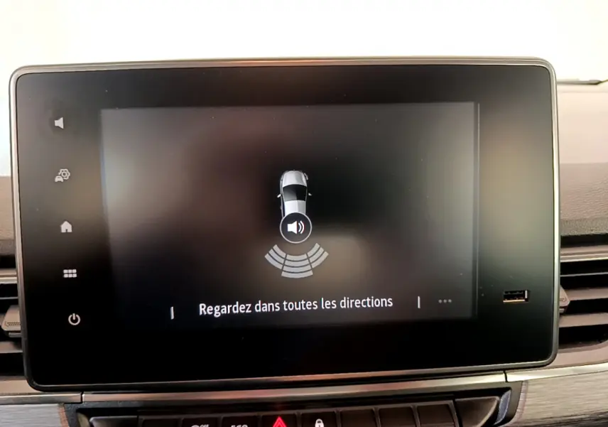 Écran tactile central du tableau de bord du Renault Kangoo bleu 2023 affichant l'aide au stationnement.