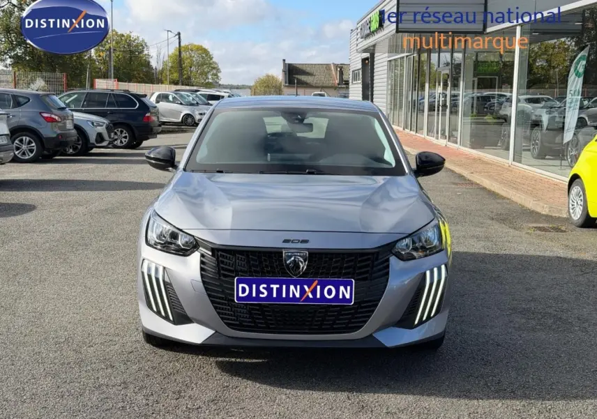 Peugeot 208 gris Artense vue de face, mettant en valeur la calandre noire et les feux LED verticaux distinctifs.