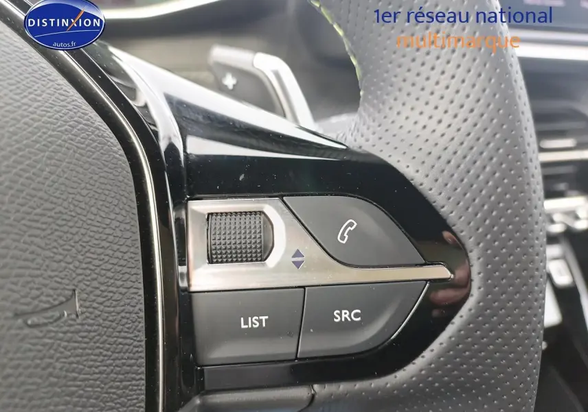 Gros plan sur les commandes gauche du volant cuir perforé du Peugeot 2008 1.2 hybrid 145 GT e-EAT8.