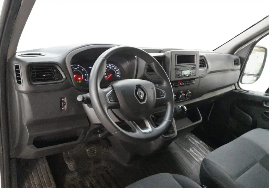 Vue intérieure côté conducteur du Renault Master 2023, tableau de bord noir avec volant multifonction et console centrale intégrée.