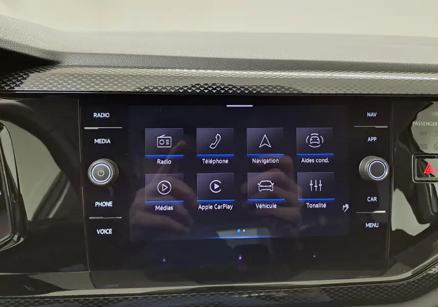 Écran tactile central de la Volkswagen Polo 2024 blanc pur, affichant le menu multimédia avec options radio et navigation.