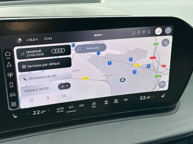 Écran tactile central de l'Audi Q3 2026 affichant la navigation GPS et les commandes climatisation en intérieur noir.