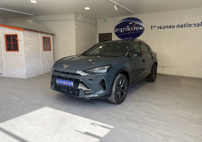 Vue 3/4 avant droite du CUPRA Formentor gris 2026 en showroom, avec jantes noires et calandre marquée.