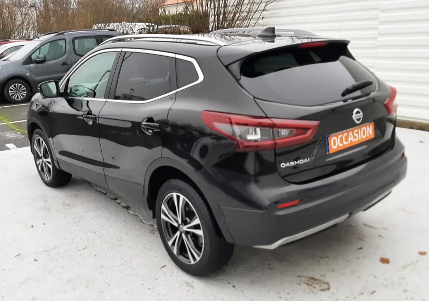 Vue 3/4 arrière droite d'un Nissan Qashqai noir 2020 avec jantes alliage et vitres teintées, stationné en extérieur.