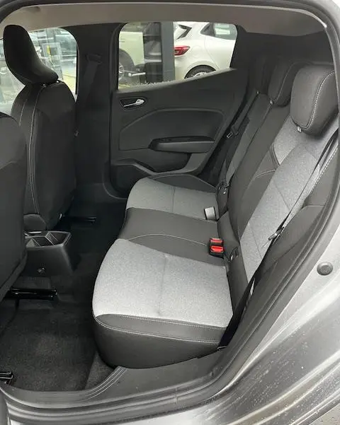 Vue intérieure côté droit des sièges arrière gris clair et foncé de la Renault Clio noir 2025 avec ceinture de sécurité et appuie-têtes.