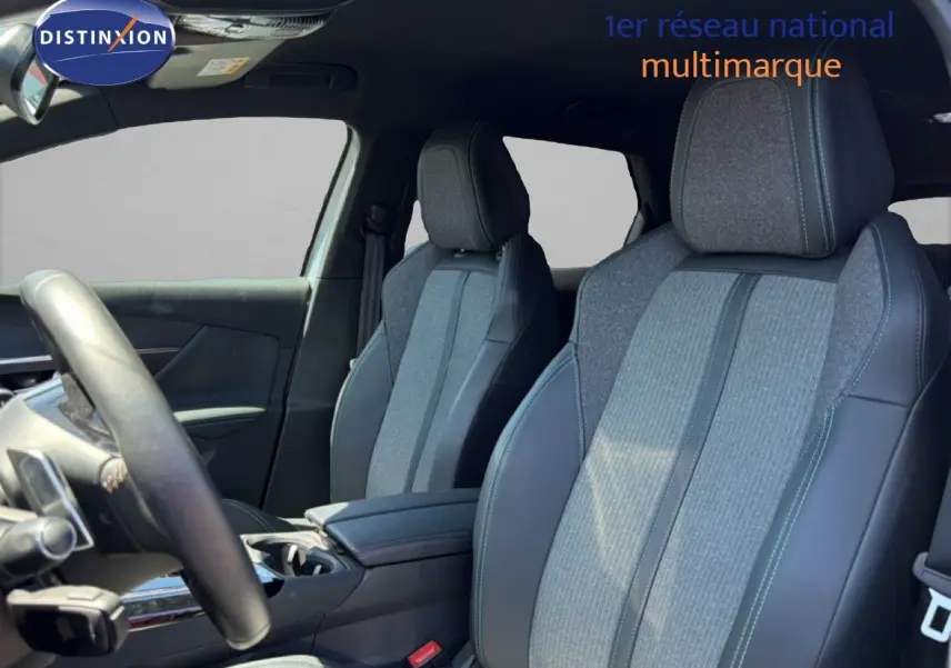 Vue intérieure côté conducteur du Peugeot 3008 Hybrid 180ch Allure 2024, sièges tissu et cuir gris avec surpiqûres bleues.