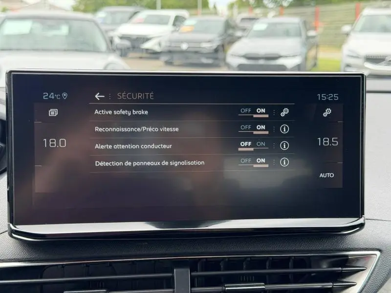 Écran tactile central du Peugeot 3008 2024 affichant les réglages de sécurité, avec tableau de bord en arrière-plan flou.