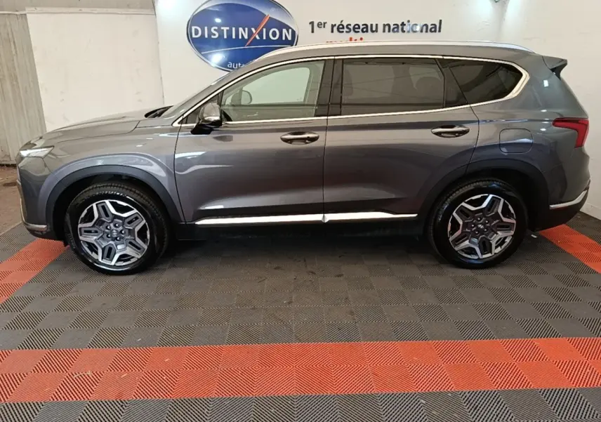 Vue de profil côté gauche du Hyundai Santa Fe gris foncé 2023 avec jantes alliage et vitres teintées.