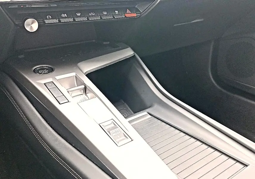 Vue intérieure de la console centrale de la Peugeot 408 Hybrid 145 allure 2024, avec commandes de boîte auto et bouton Drive Mode.