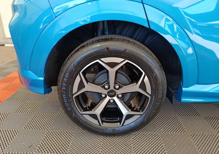 Gros plan sur la roue avant droite du Ford Puma bleu 2025 avec jante alliage noire et argentée au design moderne.