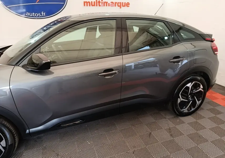 Vue de profil côté droit d'une Citroën C4 gris clair 2021 avec jantes noires et toit noir contrasté.