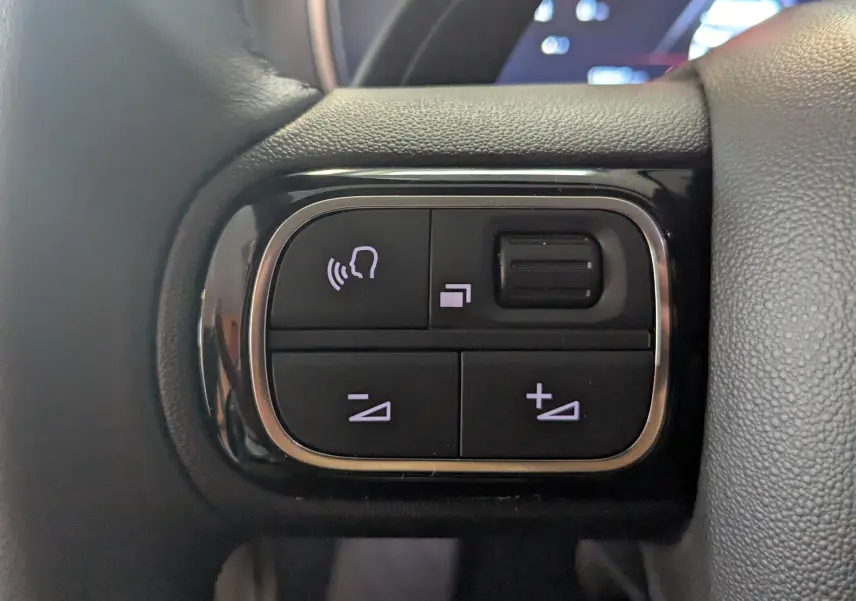 Boutons de commande au volant côté gauche du Citroën C5 Aircross gris, avec réglage volume et commandes vocales.