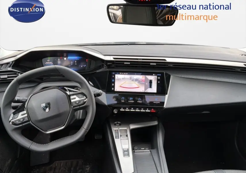 Vue intérieure avant du tableau de bord noir de la Peugeot 308 1.2 Hybrid 145ch avec écran tactile et volant multifonction.