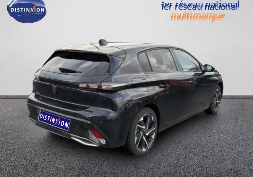 Vue 3/4 arrière droite d'une Peugeot 308 noire métal 2025 avec feux arrière LED et jantes alliage bicolores.