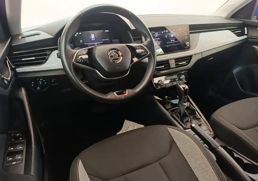 Vue intérieure avant du Skoda Scala 2024, volant cuir alu multifonctions et tableau de bord avec écran tactile central.