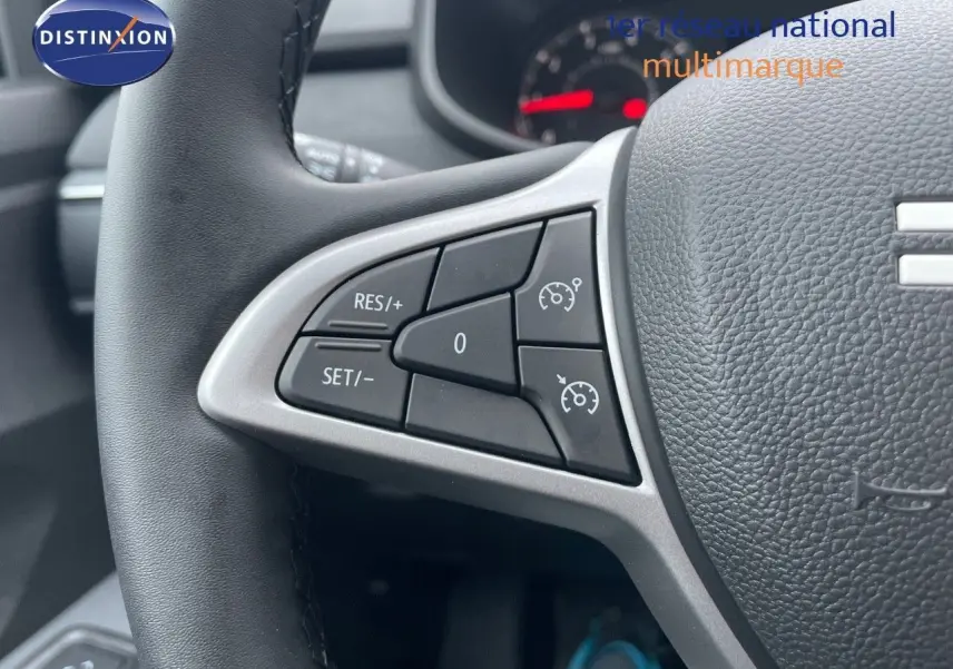 Gros plan sur les commandes de régulateur de vitesse au volant en cuir noir de la Dacia Sandero Stepway 2024.