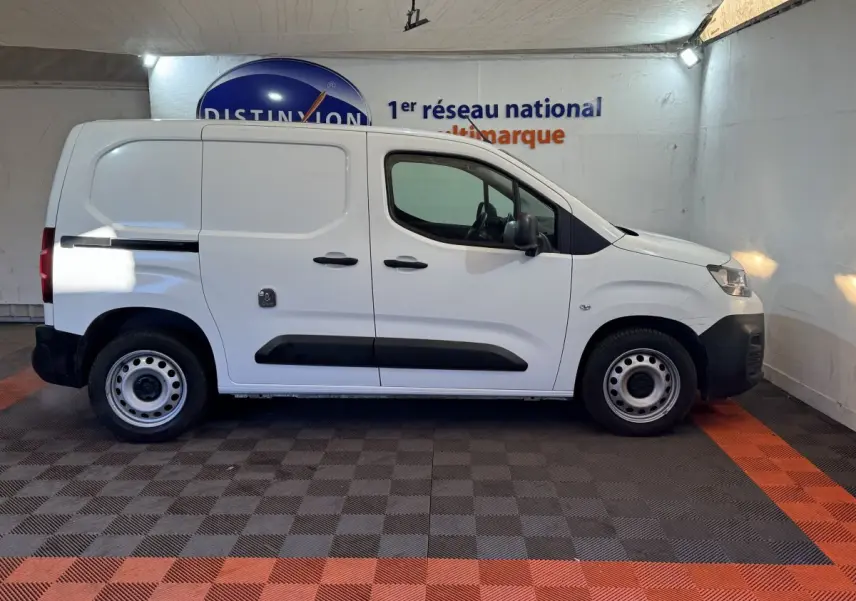 Vue de profil droit d’un utilitaire Citroën Berlingo blanc 2020 avec portes latérales pleines et jantes acier.