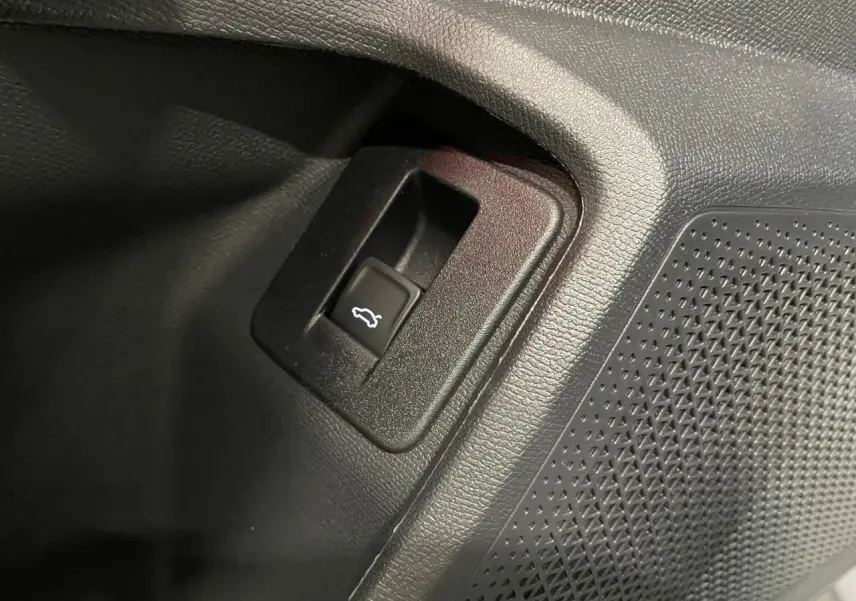 Détail du bouton d'ouverture du hayon sur la contre-porte intérieure noire du CUPRA Formentor gris Graphene.