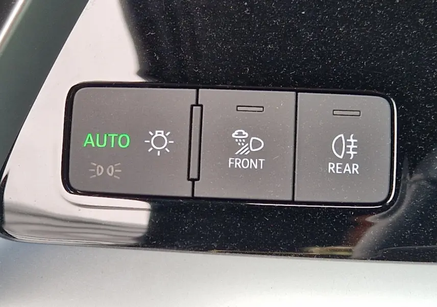 Gros plan sur les boutons de commande d'éclairage automatique et antibrouillard avant/arrière dans l'habitacle noir de l'Audi A3 Sportback.