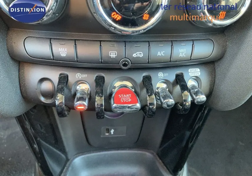 Détail du tableau de bord de la MINI 1.5 136CH STEPTRONIC 2023 montrant les commandes et le bouton rouge Start/Stop.