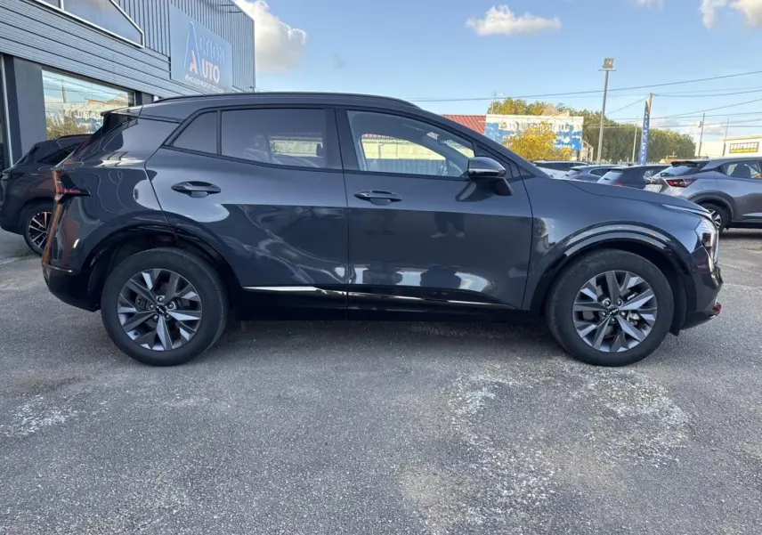 Vue latérale gauche du KIA SPORTAGE 2025 gris Eclipse Métallisée avec jantes alliage et vitres surteintées.