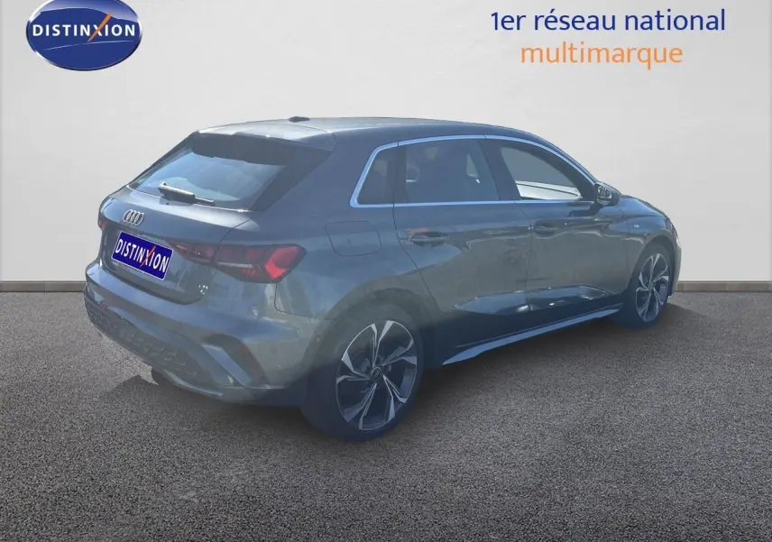 Audi A3 Sportback gris Daytona métal vue 3/4 arrière droit, jantes alliage et lignes S-Line distinctives.