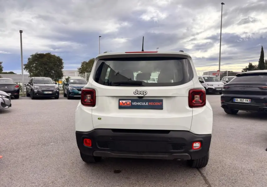 Vue arrière d'un Jeep Renegade blanc 2024 avec feux carrés rouges et badge e-Hybrid visible sur le coffre.