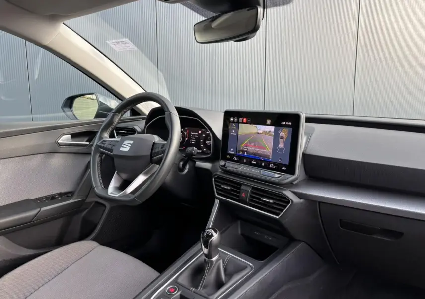 Vue intérieure côté conducteur du SEAT Leon 2.0 TDI 115 Style 2025, avec écran tactile affichant la caméra de recul.