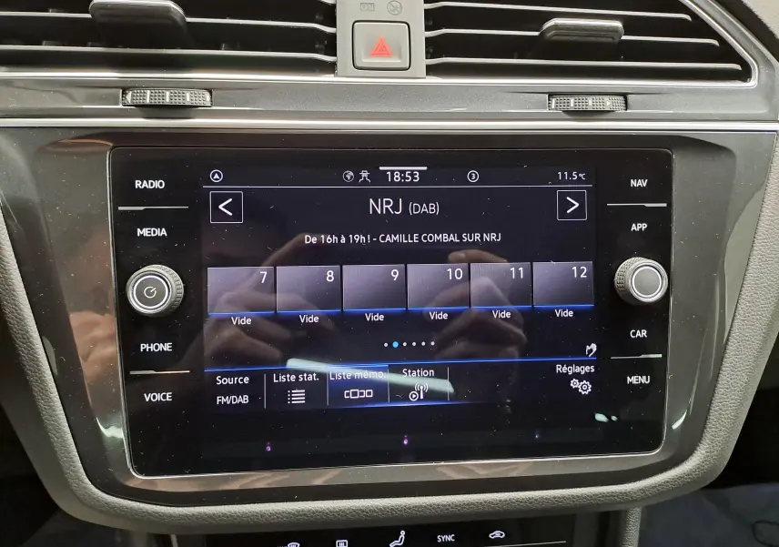 Écran tactile central du Volkswagen Tiguan 2022 affichant la radio NRJ, entouré de commandes media et navigation.
