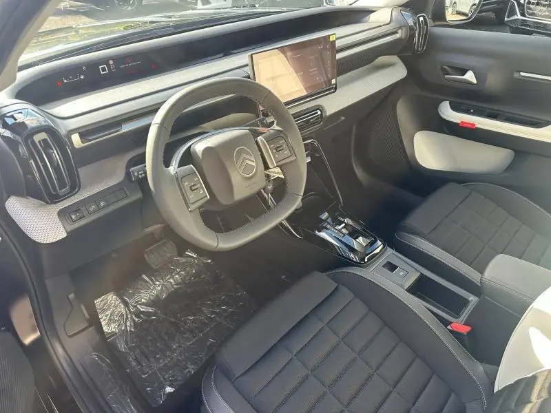 Vue intérieure côté conducteur du Citroën C3 Aircross noir 2026, avec volant multifonction et écran tactile central.