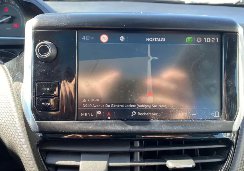 Écran tactile central du tableau de bord du Peugeot 2008 2019, affichant la navigation GPS en plein jour.