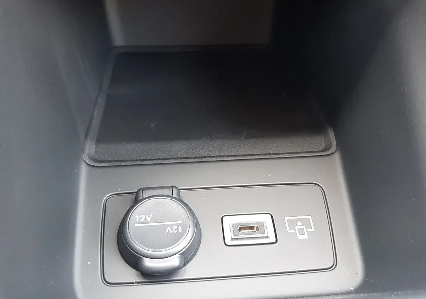 Prise 12V et port USB intégrés dans la console centrale de la Peugeot 308 gris sélénium, intérieur sobre.