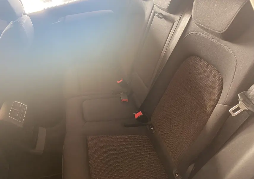 Vue intérieure des sièges arrière en tissu gris foncé de l'Audi Q5 2012, avec ceintures de sécurité et aérateurs centraux.