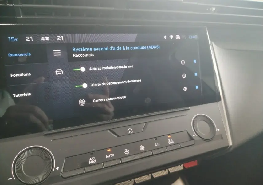 Écran tactile du système d'aide à la conduite dans l'habitacle du Peugeot 308 SW Hybrid 145 gris Artense.