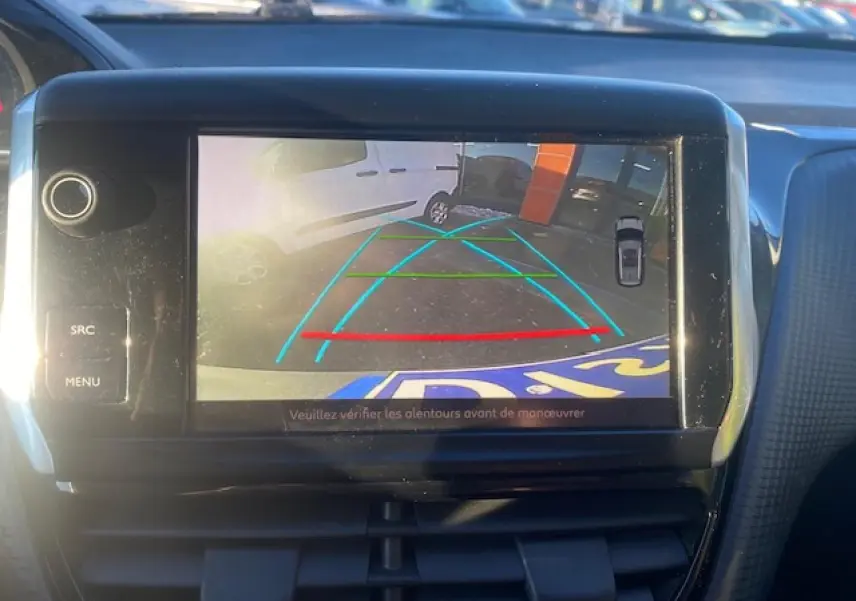Écran tactile intérieur montrant la caméra de recul du Peugeot 2008 gris Artense avec lignes de guidage colorées.