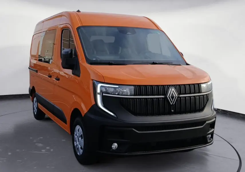 Renault Master orange en 3/4 avant droit, avec calandre noire marquée et phares LED en forme de C.