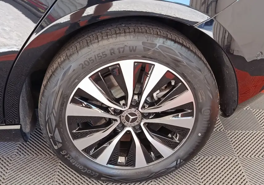 Gros plan sur la jante alliage noir et argentée de la Mercedes Classe A 250 e Business Line noire, roue arrière droite.