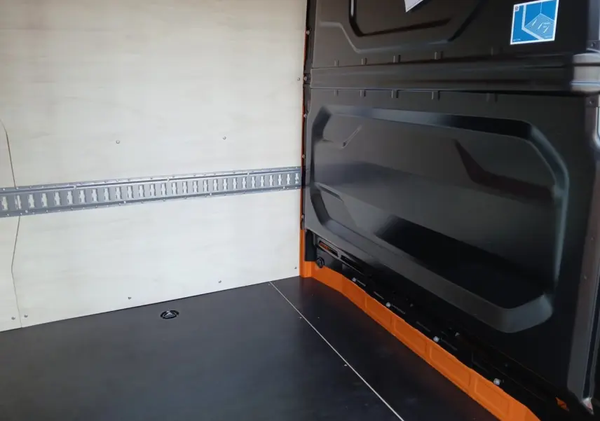 Intérieur du Renault Master L2H2 2026, vue du compartiment de chargement avec parois bois claires et plancher noir.