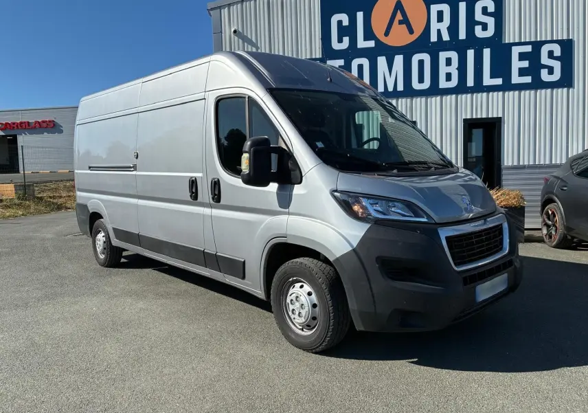 Vue 3/4 avant droit d’un Peugeot Boxer cabine approfondie gris 2019, avec calandre noire et pare-chocs foncé.