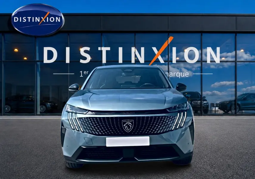 Vue avant d'un Peugeot 3008 bleu 2025 avec calandre noire distinctive et phares LED verticaux, devant une vitrine Distinxion.