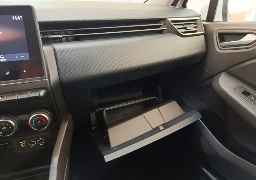 Intérieur Renault Clio Business TCe 90 2020, vue côté passager sur la boîte à gants ouverte et tableau de bord noir.