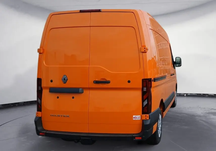 Vue arrière d’un Renault Master L2H2 orange 2026 avec hayon fermé et attelage visible sous le pare-chocs.