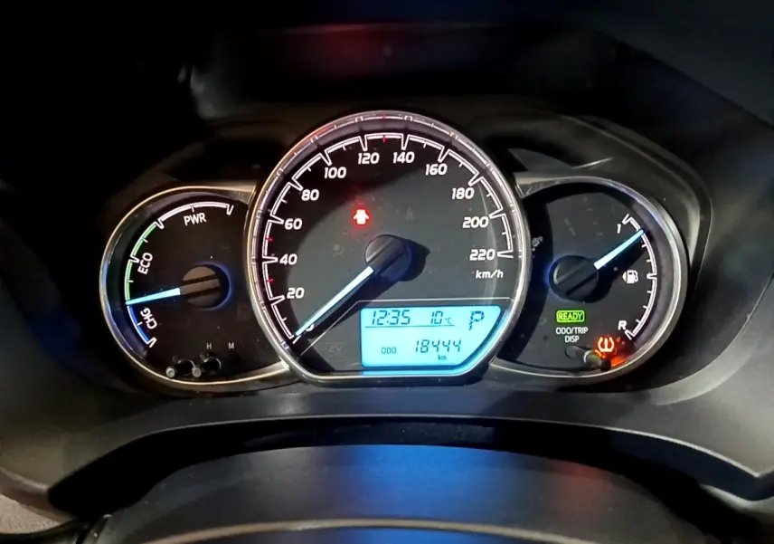 Tableau de bord de Toyota Yaris hybride 2019, affichage digital bleu avec compteur de vitesse et jauges énergie et carburant.